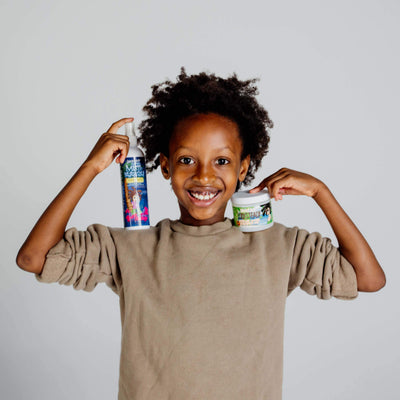 Boy with dreadlocks is holding Knotty boy hair products
